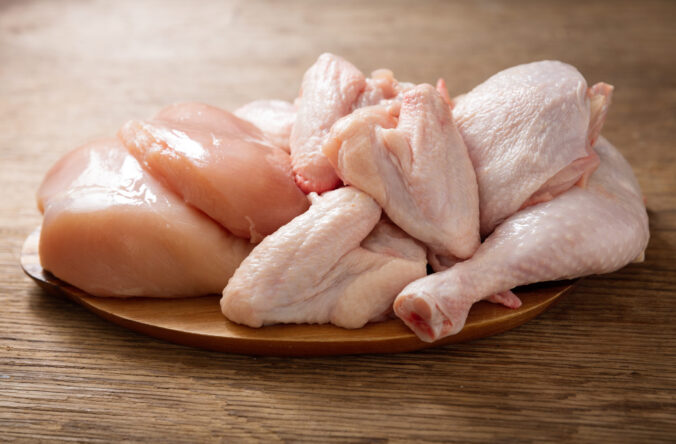 fresh chicken meat on a wooden board