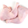 Raw chicken leg quarters, isolated on white background.